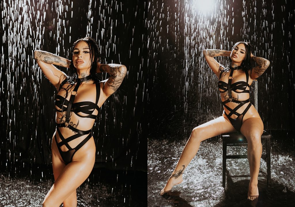 Woman in black strappy lingerie sitting on a chair under a rain set in a photo studio. 
