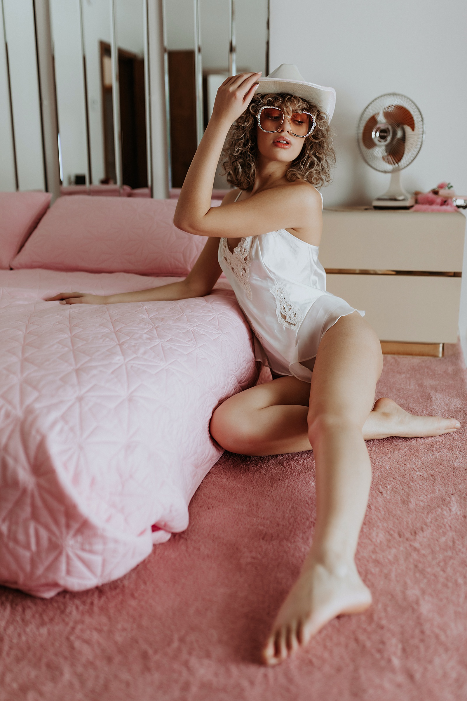 Woman in lingerie on pink bed by Minneapolis boudoir photographer, Mary Castillo 