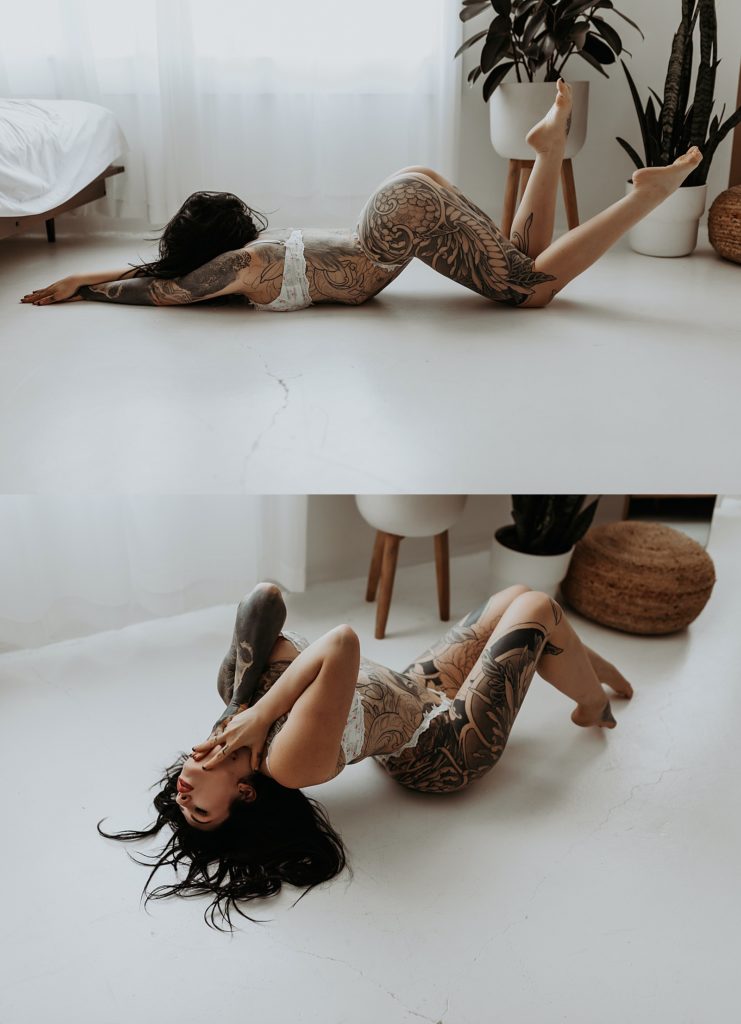 Black haired woman in white lingerie lying on a white floor in photo studio 