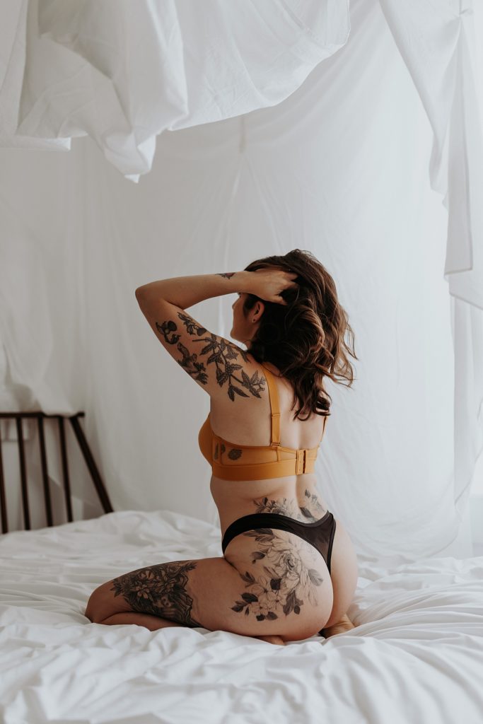 Woman with tattoos at her intimate portrait session