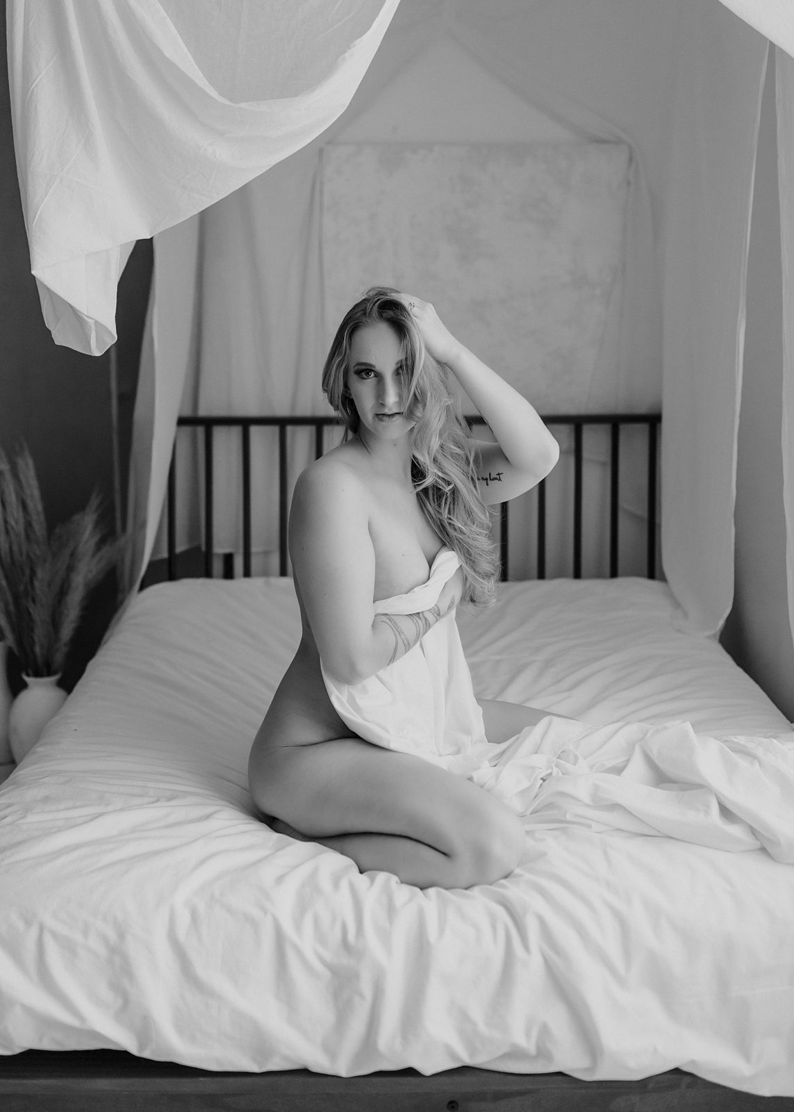Nude woman covering herself with a sheet by Mary Castillo Photography