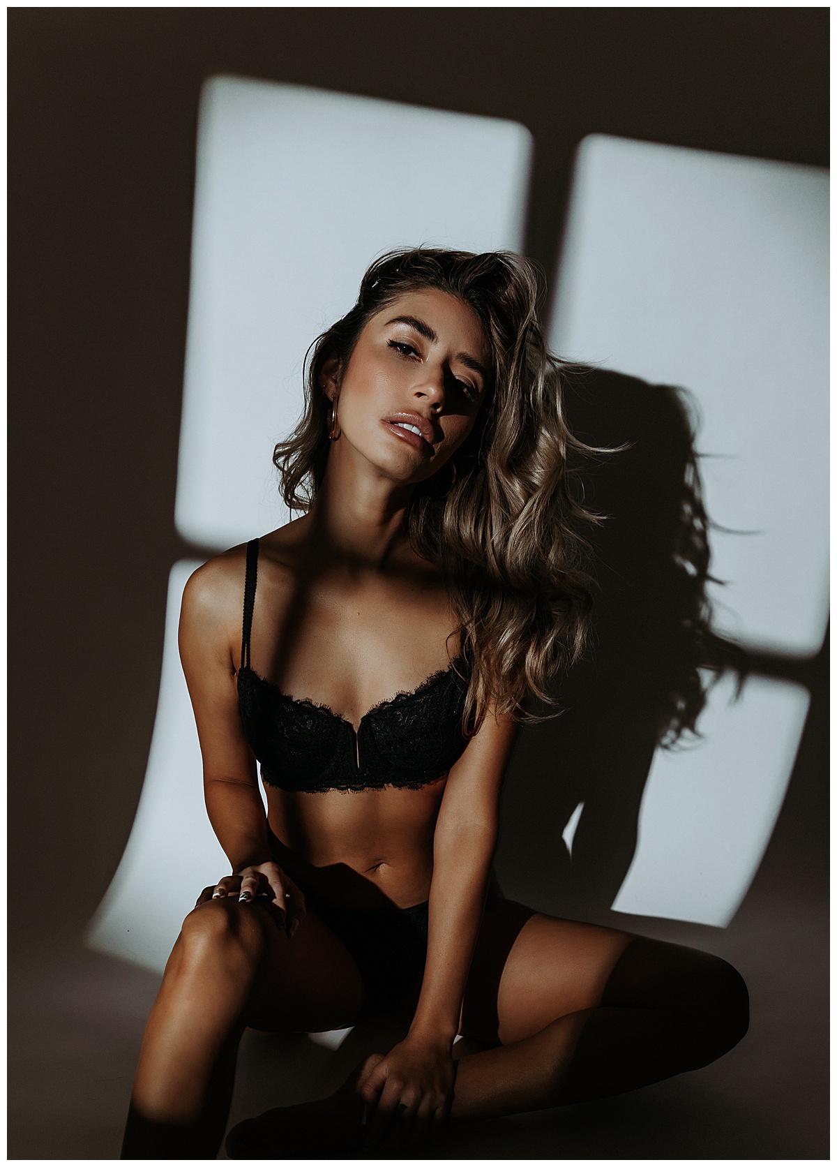 In black lingerie woman is sitting down for Mini Session After Sunset