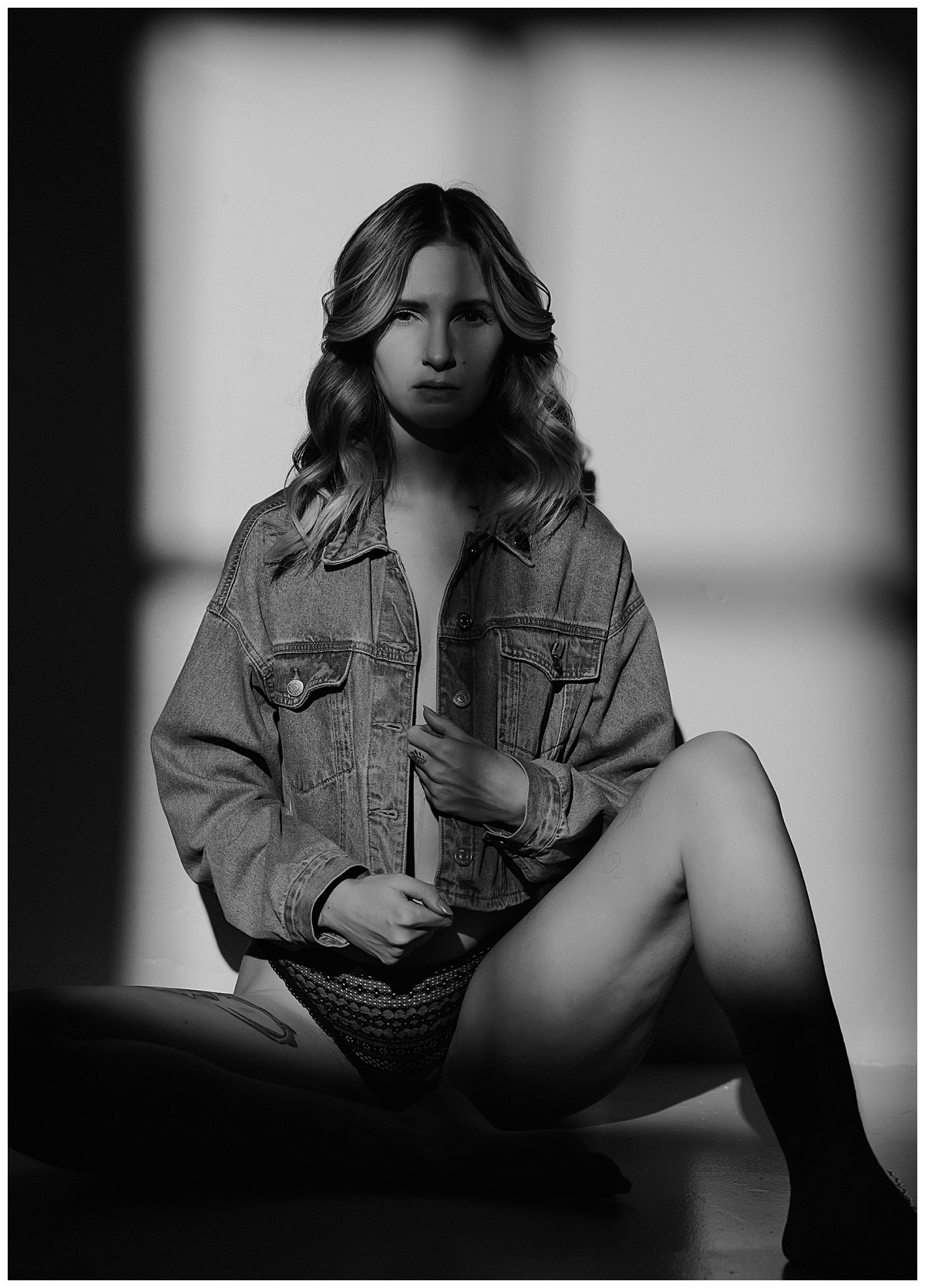 Model in jean jacket sitting down for Mary Castillo Photography