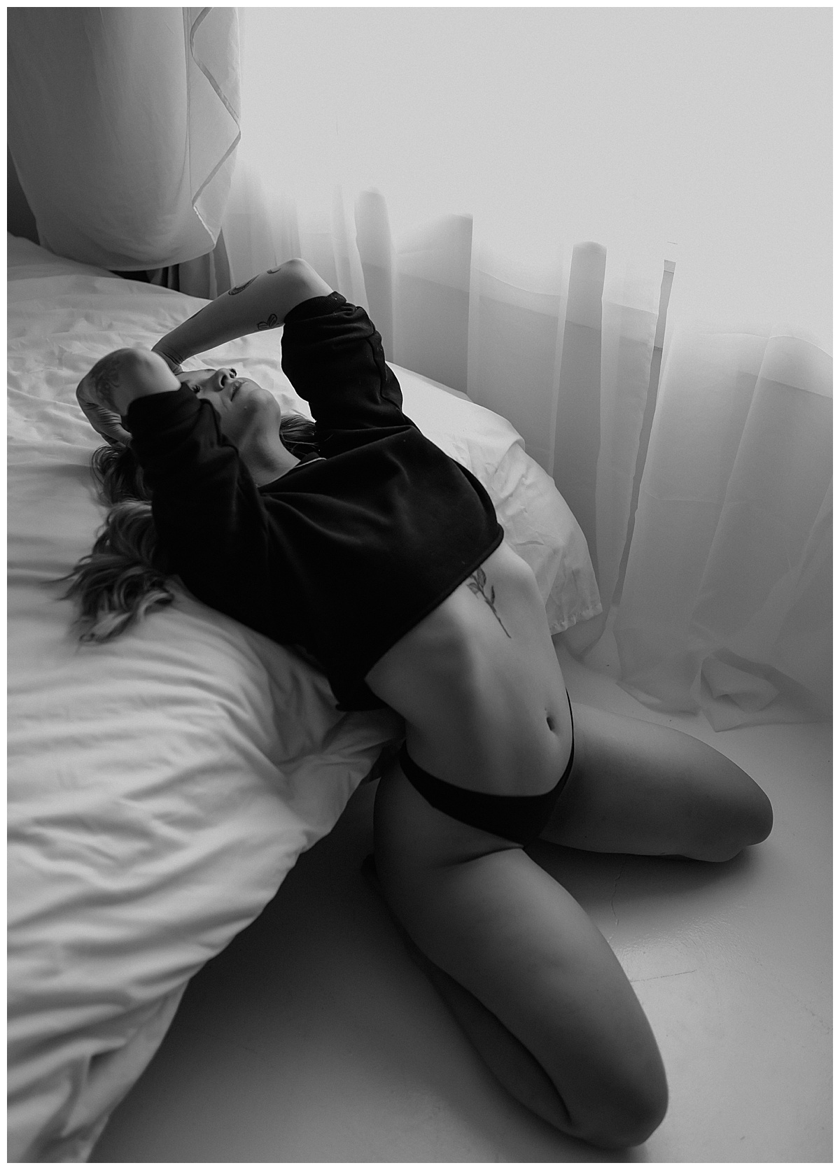 Girl leans back onto bed for Minneapolis Boudoir Photographer