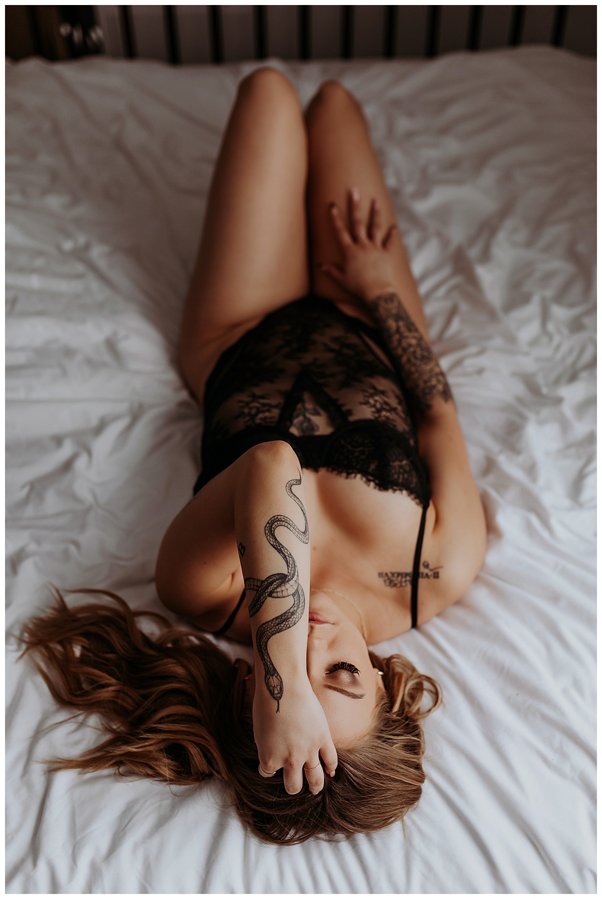 Adult lays on back on bed in Black Lingerie Styles