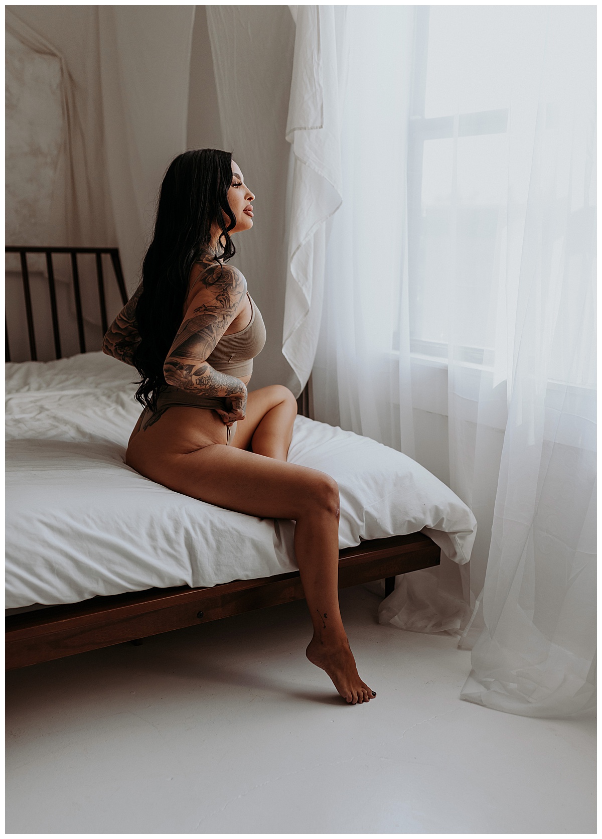 Female sits on bed for Mary Castillo Photography