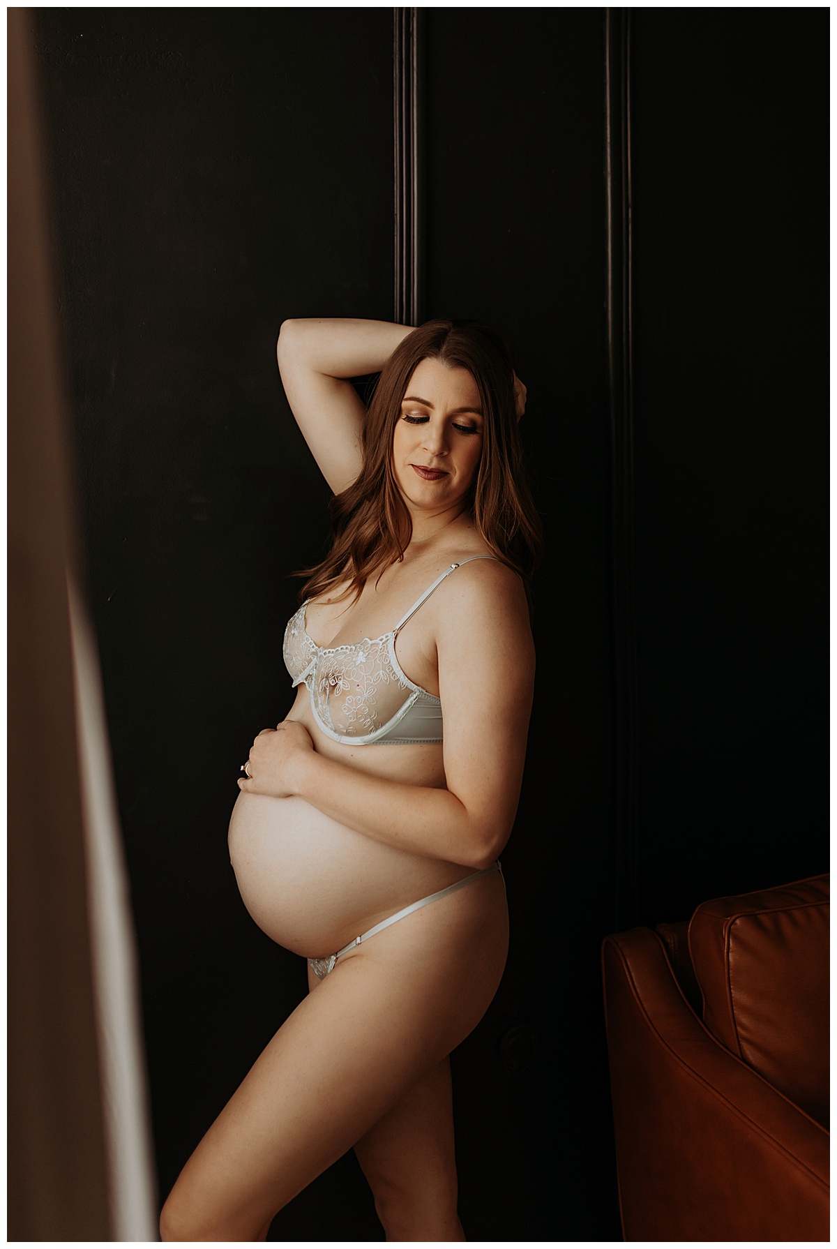 Mama grabs belly for Maternity Boudoir session