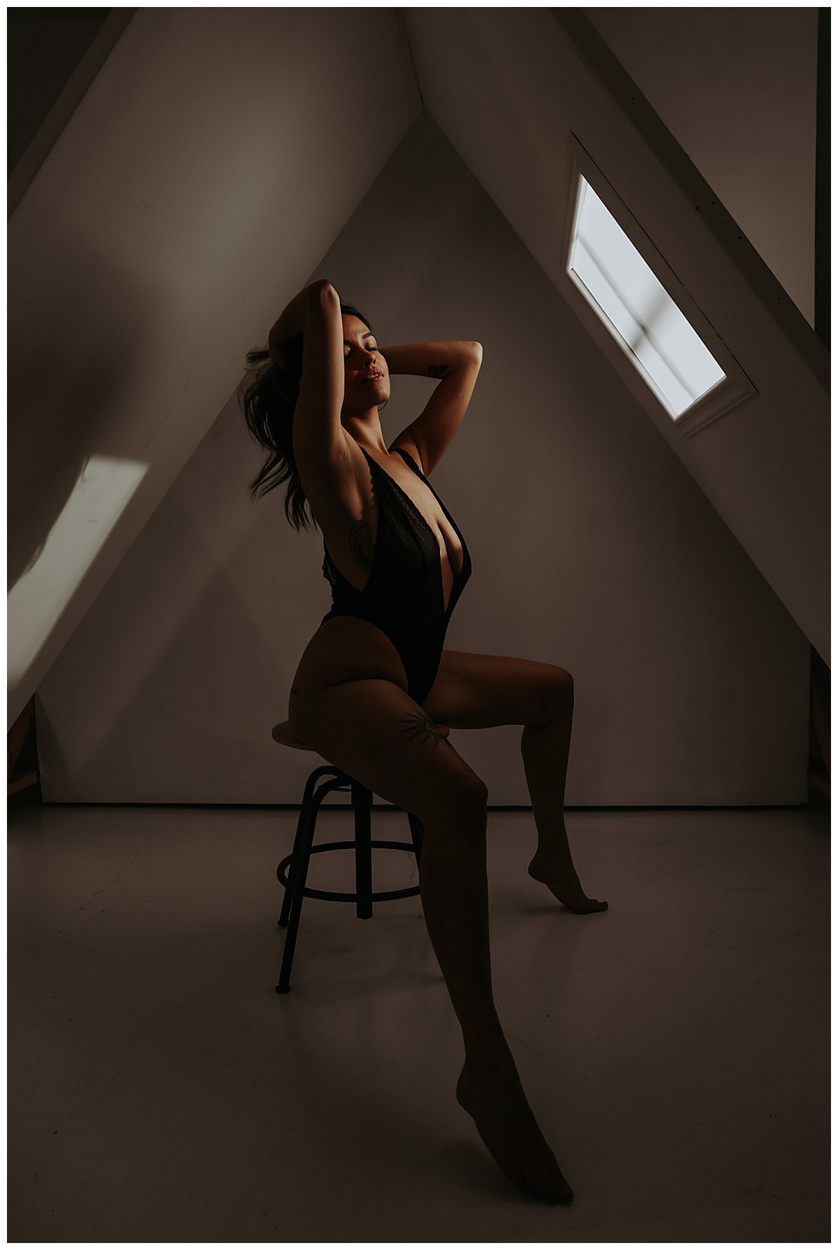 Person sits on stool wearing lingerie for Sultry Skylight Session
