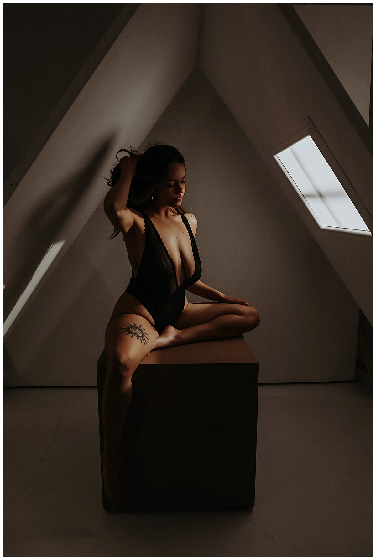 Lady runs fingers through hair in black lingerie for Sultry Skylight Session