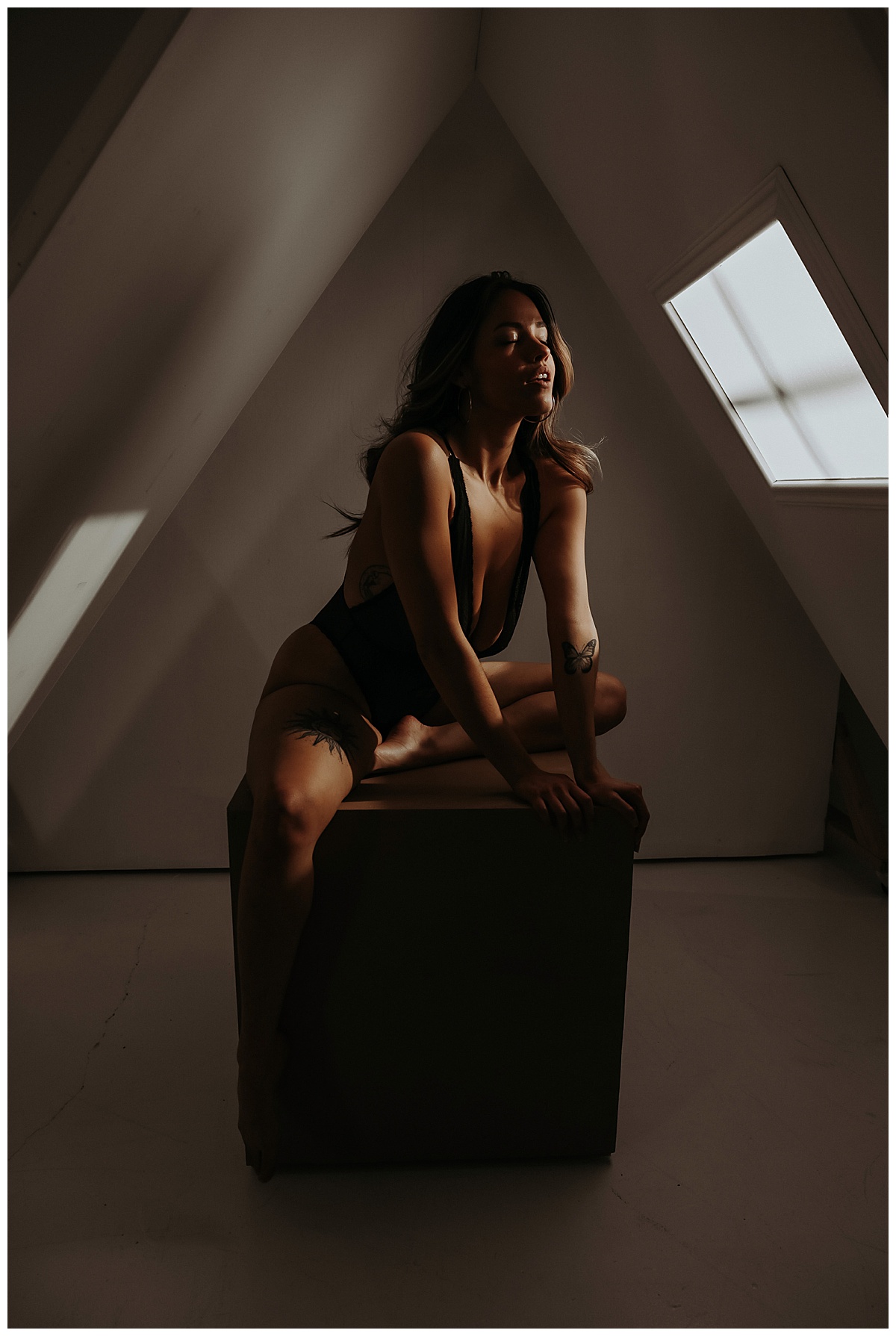 Girl sits in light on box for Mary Castillo Photography