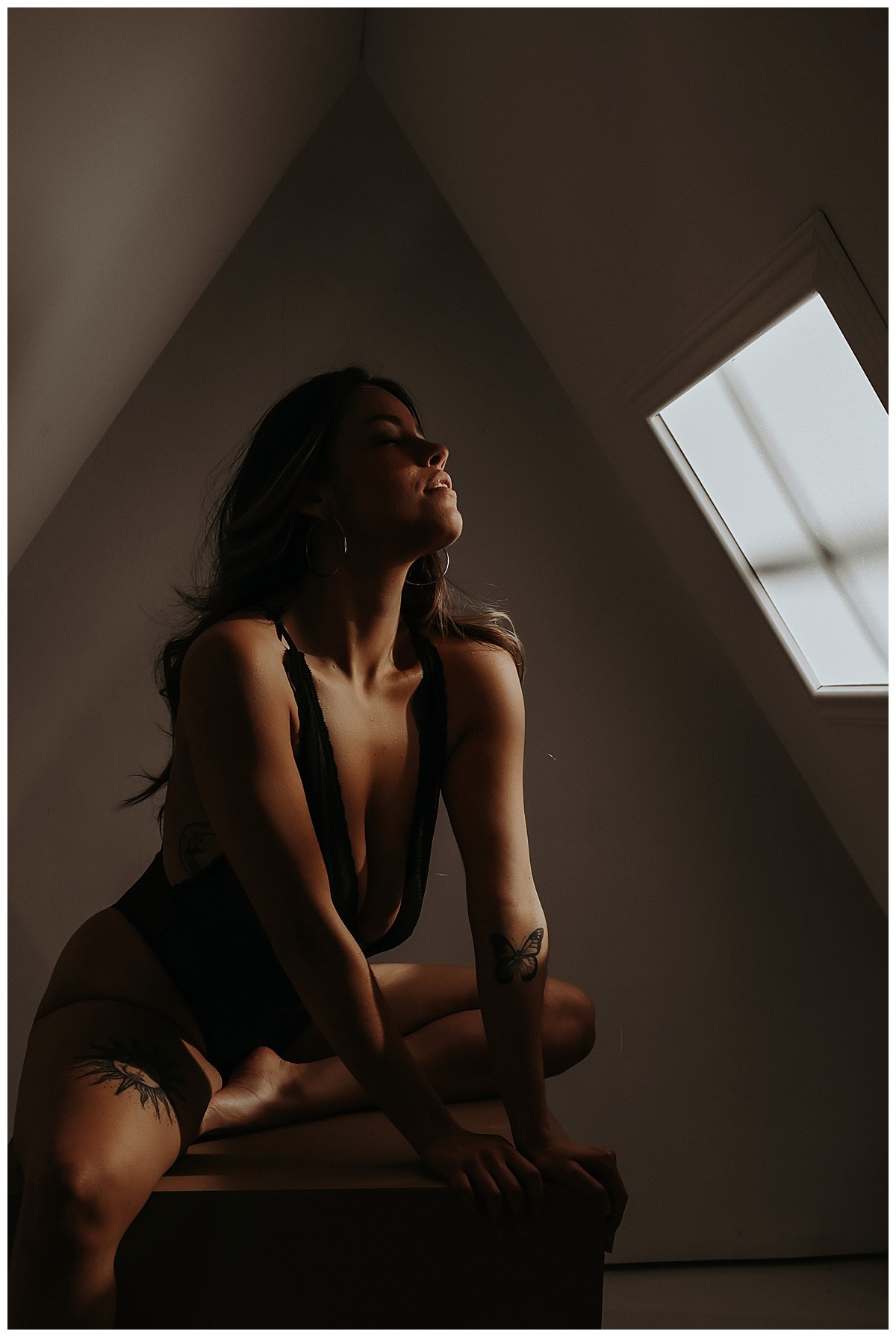 Person leans into light on box in lingerie for Sultry Skylight Session
