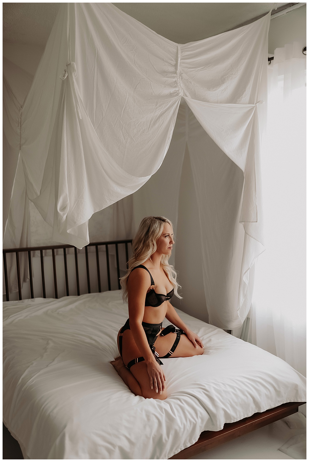 Woman sits on bed wearing Strappy Lingerie