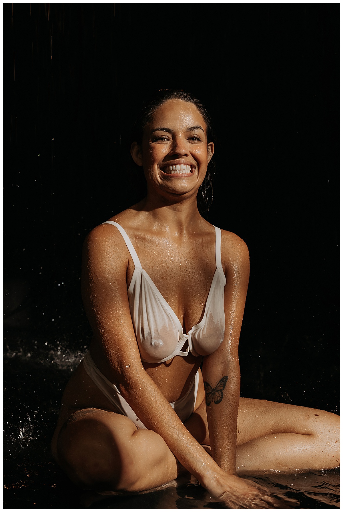 Female smiles big for Water Boudoir Photos