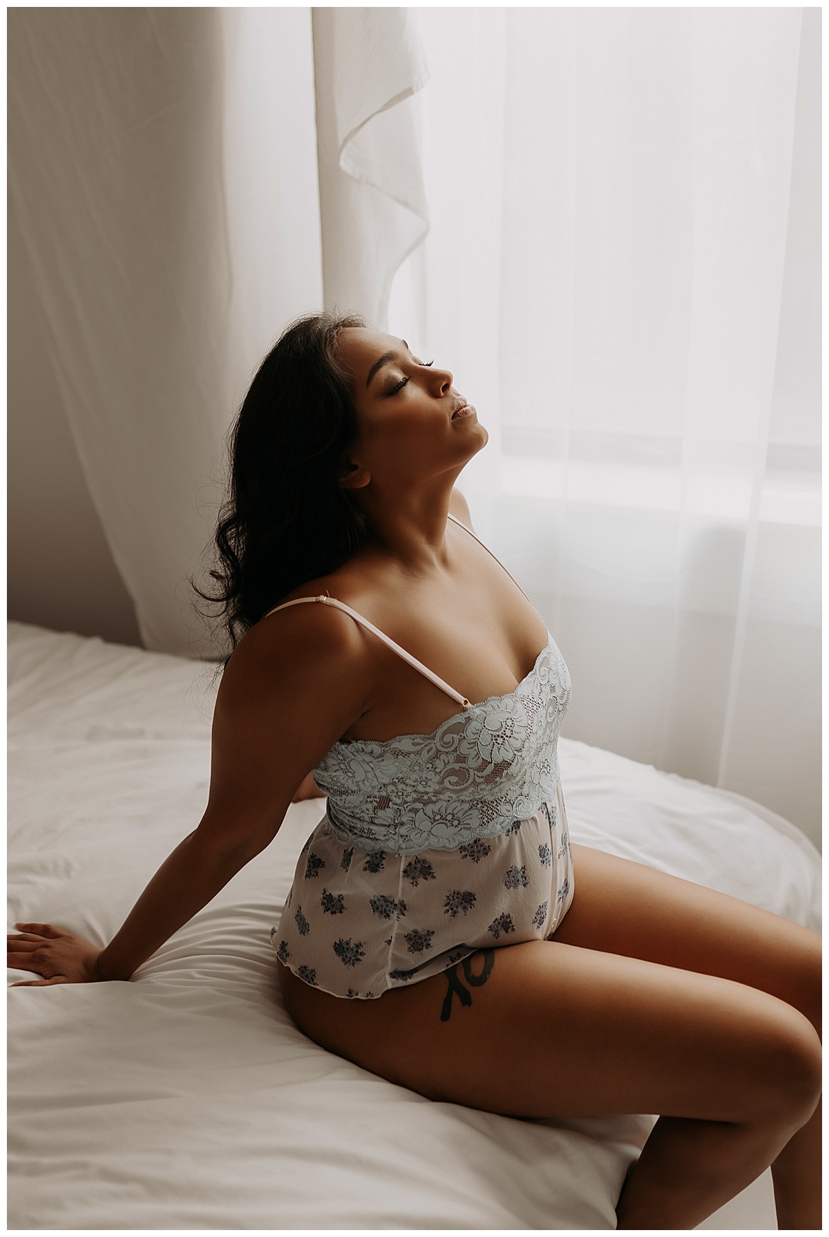 Mother lays back on edge of bed for Minneapolis Boudoir Photographer