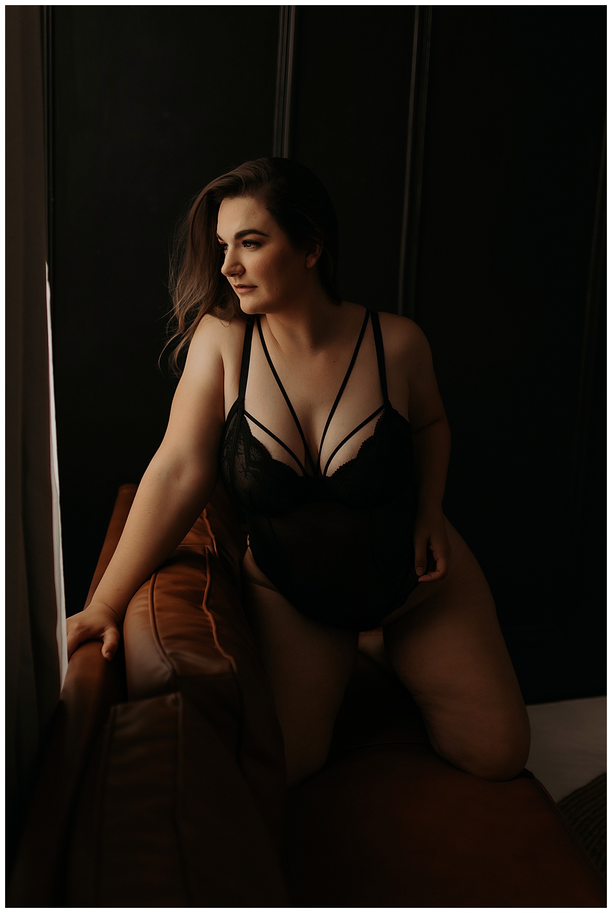 Adult sits on the couch for Minneapolis Boudoir Photographer