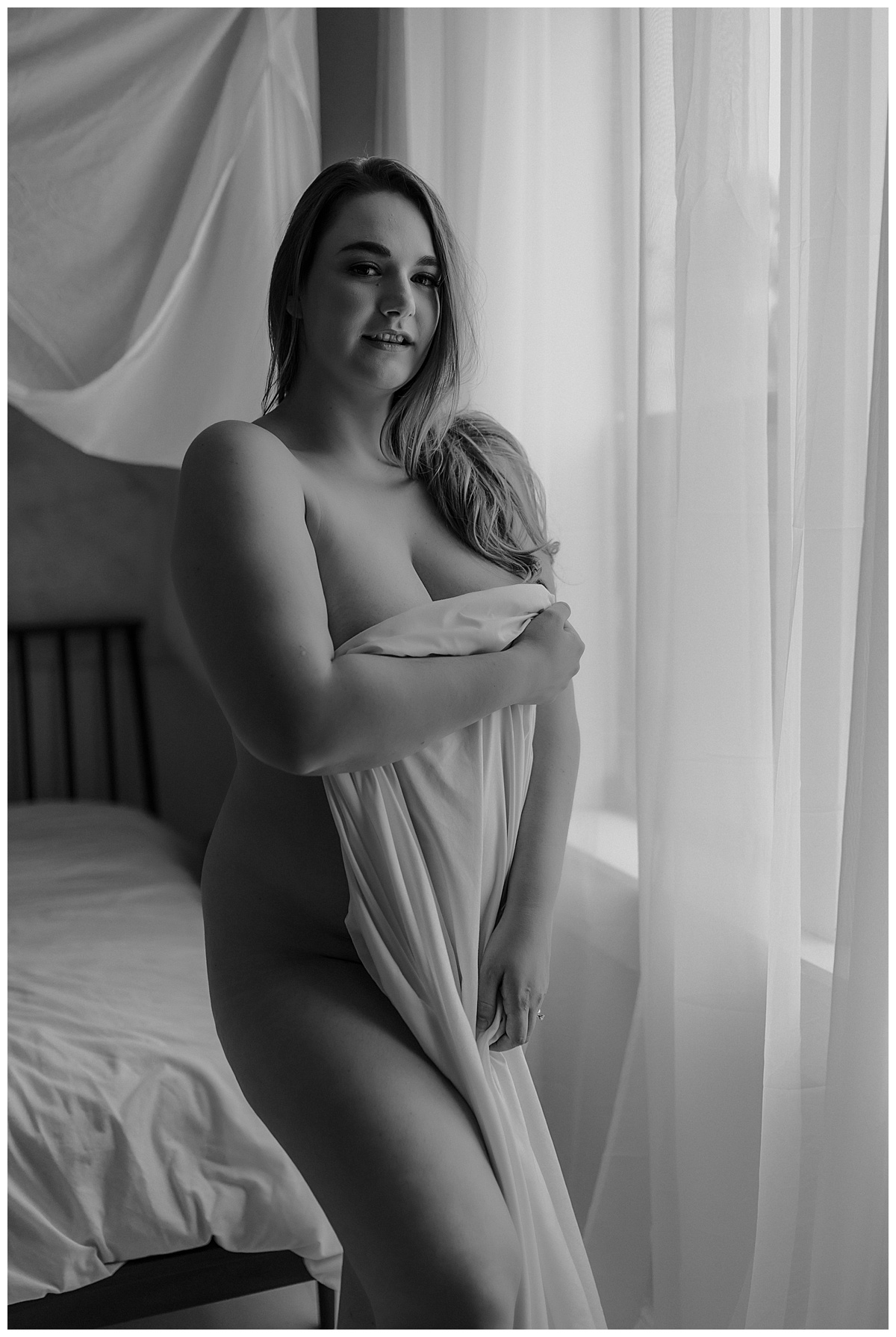 Girl covers body with white sheet for Minneapolis Boudoir Photographer