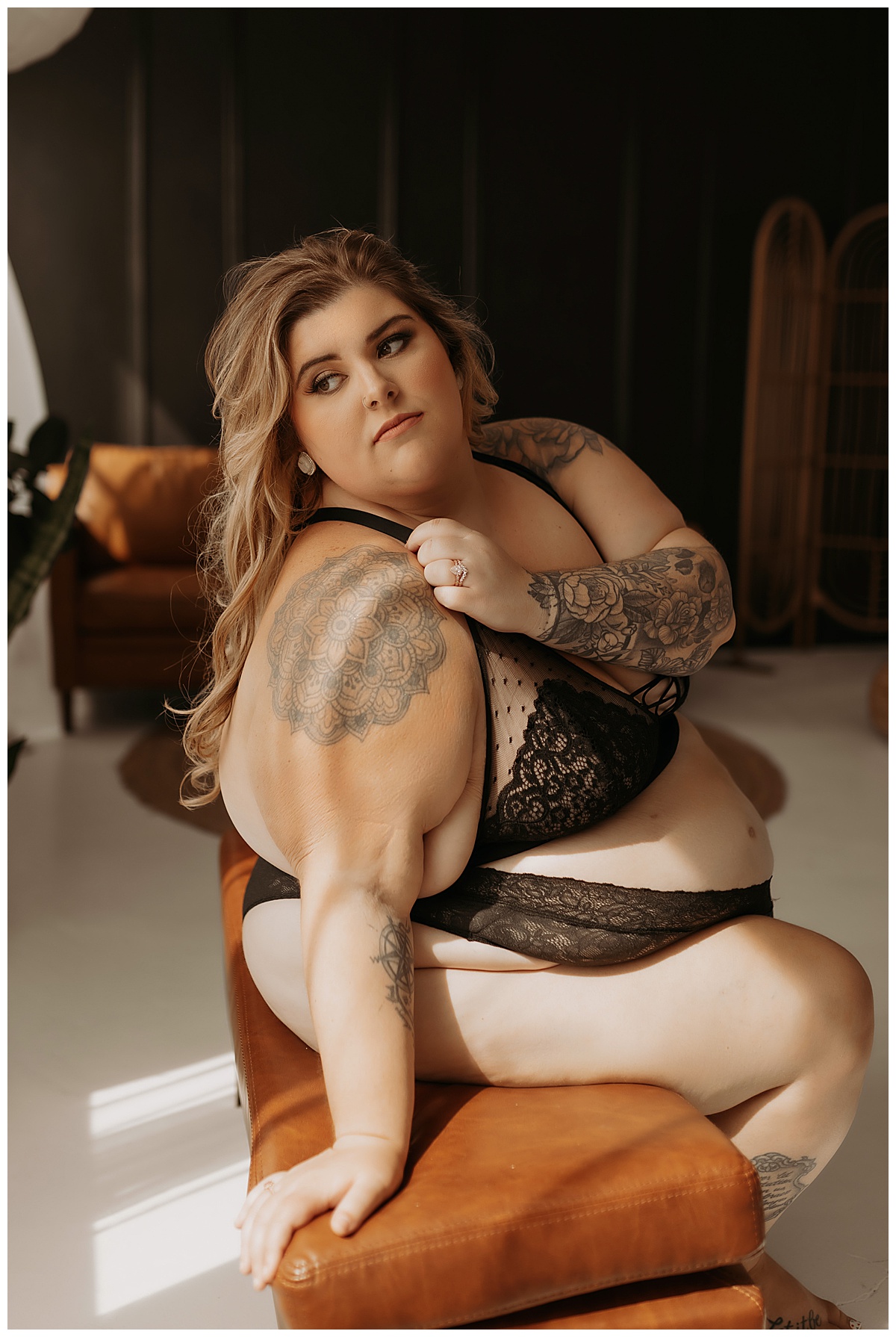 Person sits on the bench wearing black lingerie for Minneapolis Boudoir Photographer
