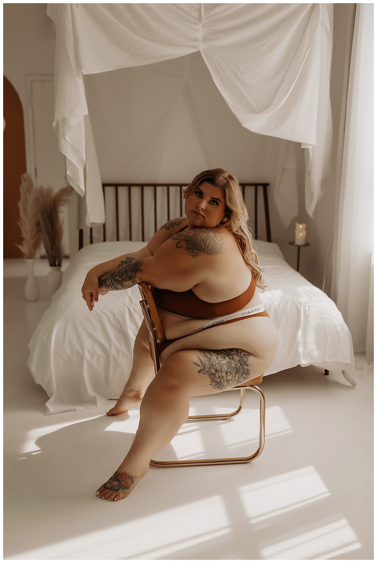 Girl sits on a chair wearing lingerie for  Minneapolis Boudoir Photographer