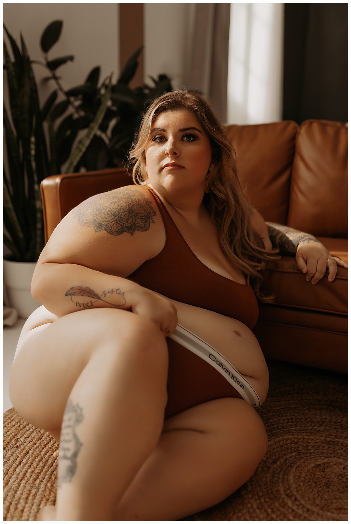 Adult leans into the couch wearing lingerie for Mary Castillo Photography