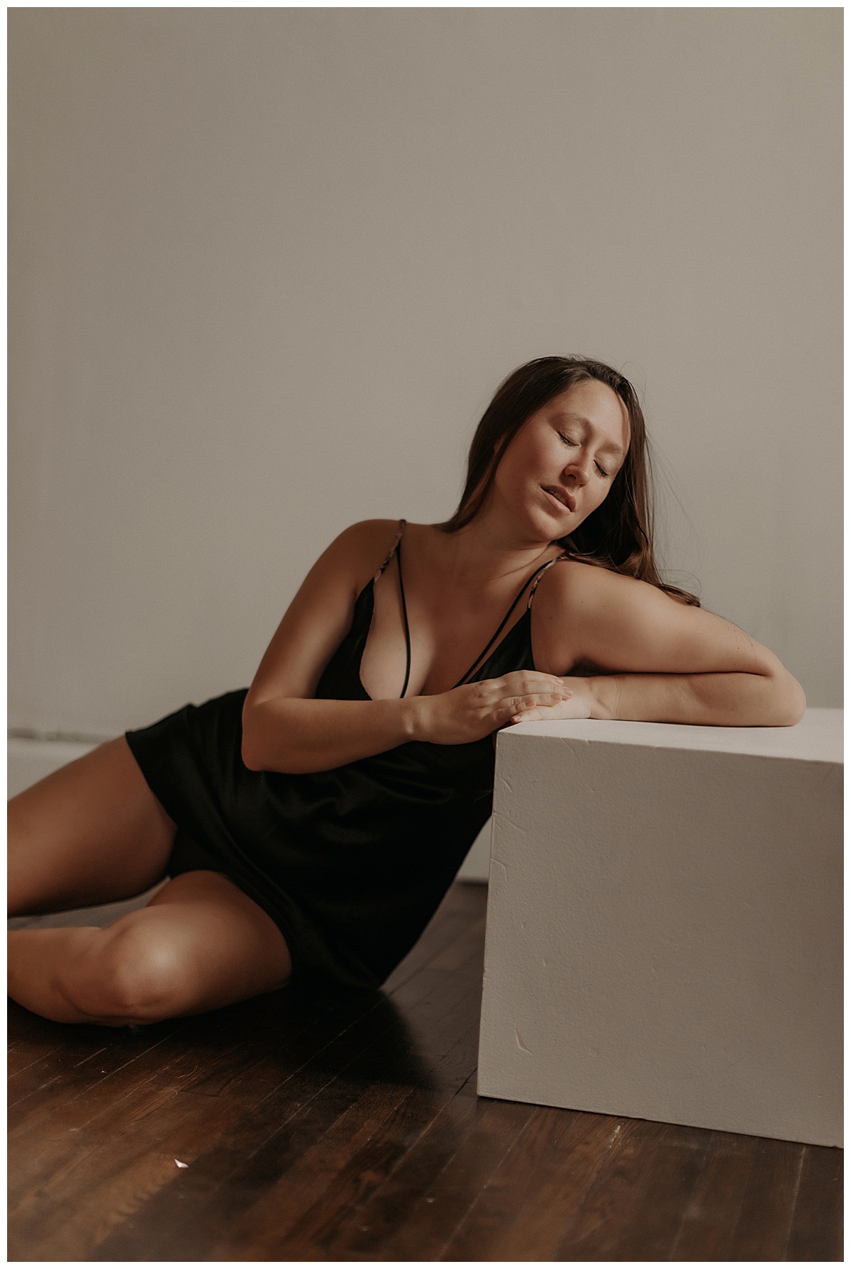 Female leans on furniture for Mary Castillo Photography