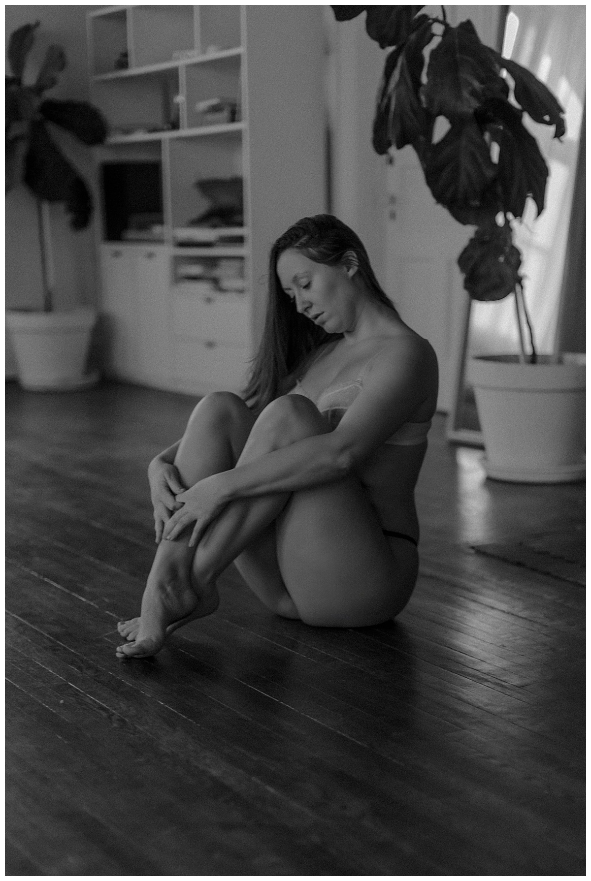 Person brings her knees to her chest for Minneapolis Boudoir Photographer