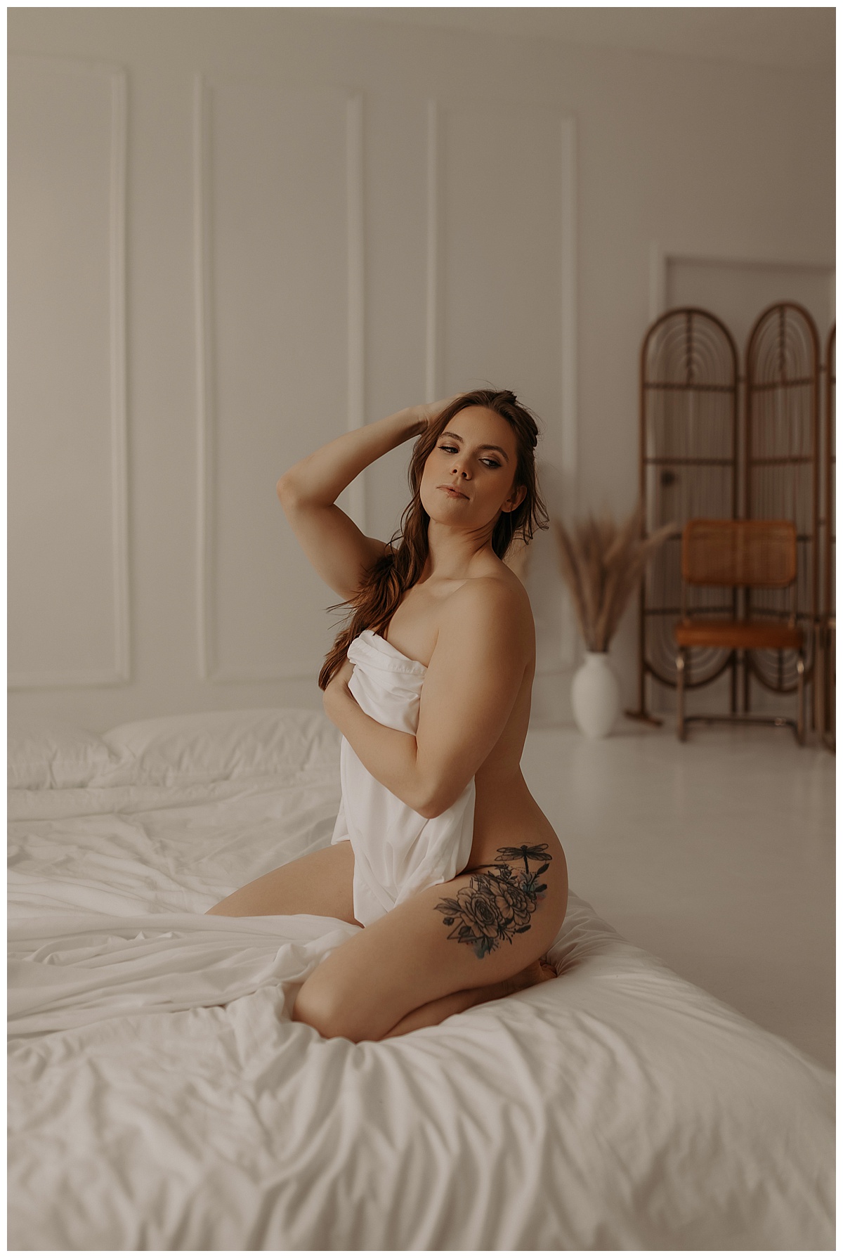 Girl wraps her body in a white sheet for Minneapolis Boudoir Photographer