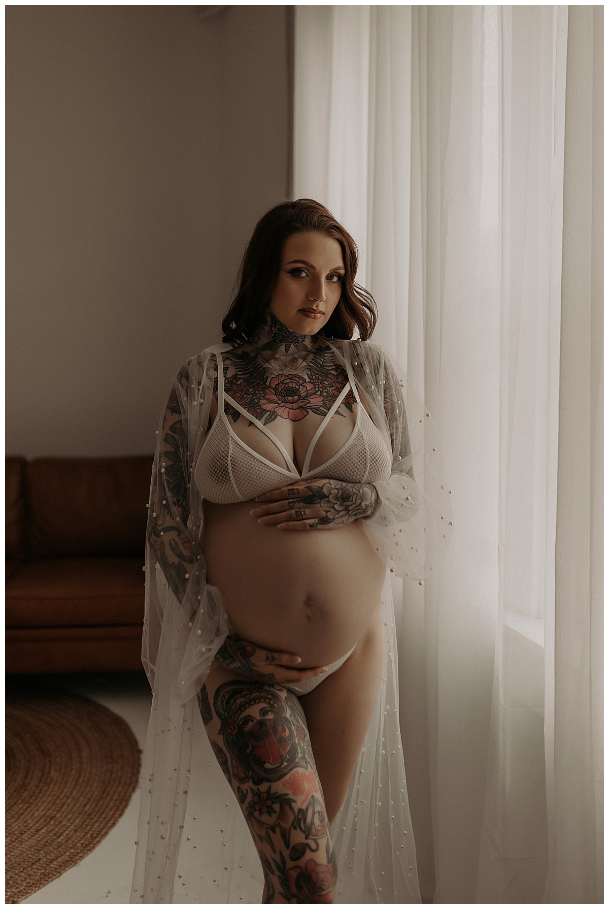 Woman holds pregnant belly for Minneapolis Boudoir Photographer