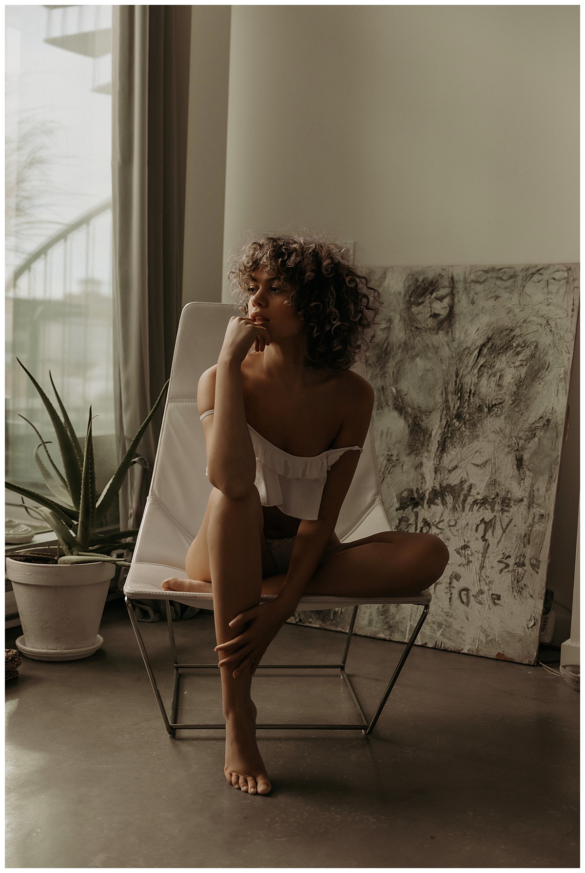Adult sits on the chair for Minneapolis Boudoir Photographer