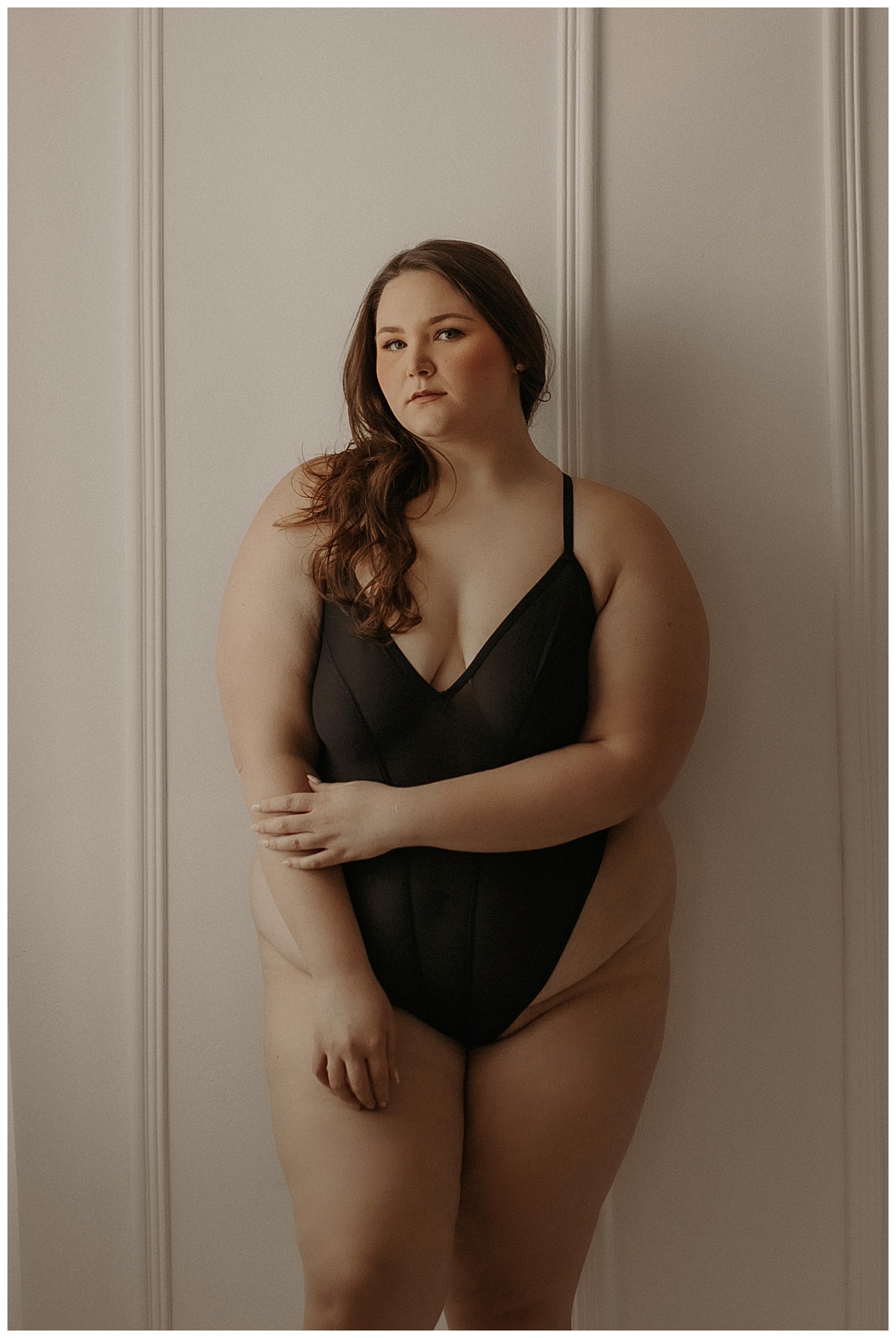 Person leans against the wall wearing black lingerie showing Why Trust And Connection With Your Boudoir Photographer Are Important 