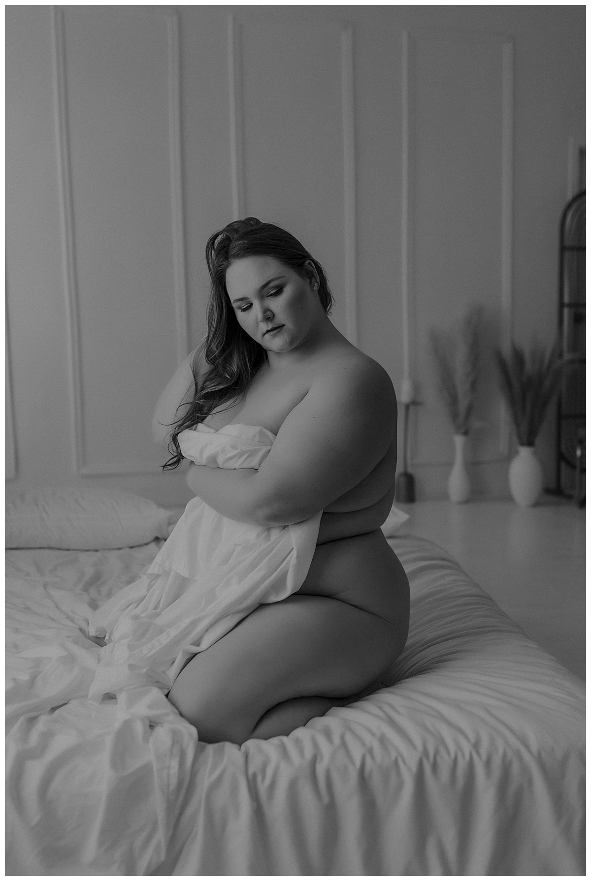 Adult covers body with white sheet for Mary Castillo Photography