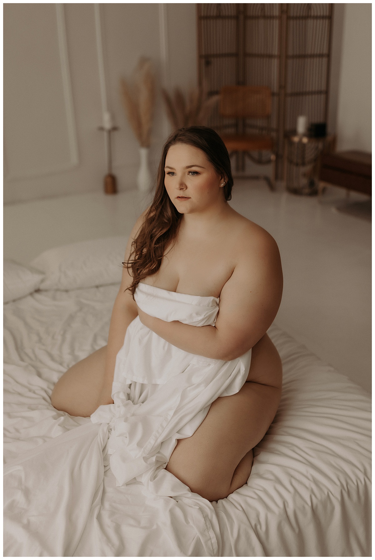 Adult covers body with white sheet showing Why Trust And Connection With Your Boudoir Photographer Are Important 