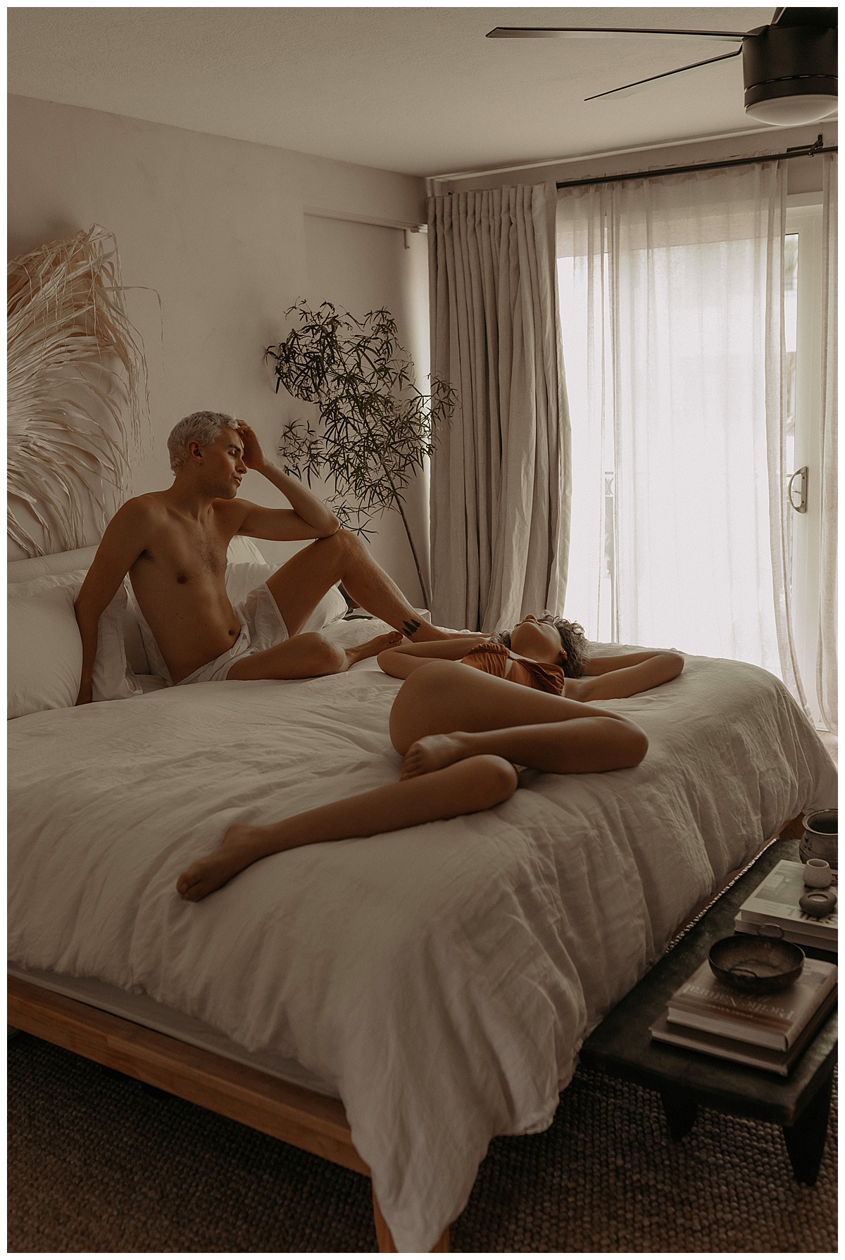 Man and woman lay on the bed together for Mary Castillo Photography