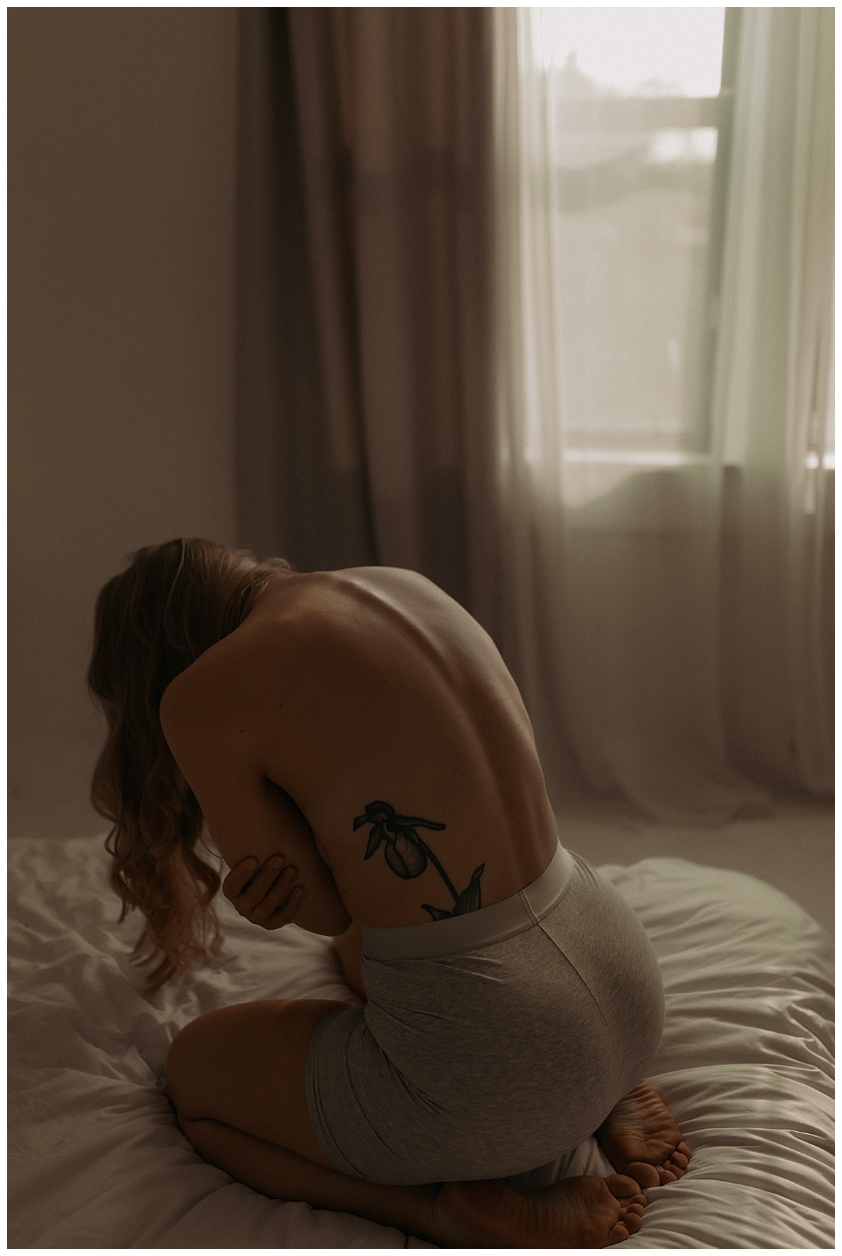 Woman leans forward for Minneapolis Boudoir Photographer