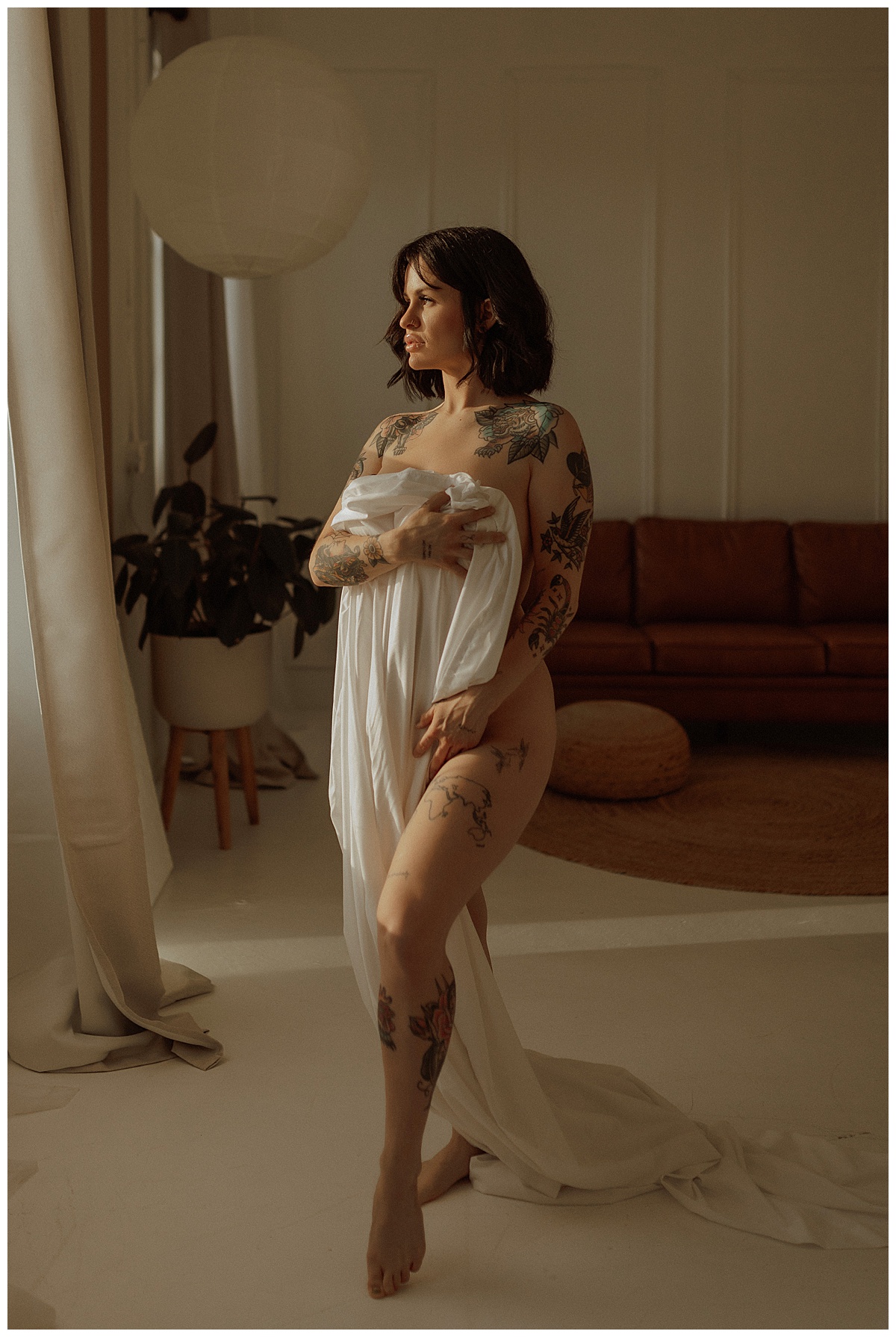 Adult covers body with white sheet for Minneapolis Boudoir Photographer