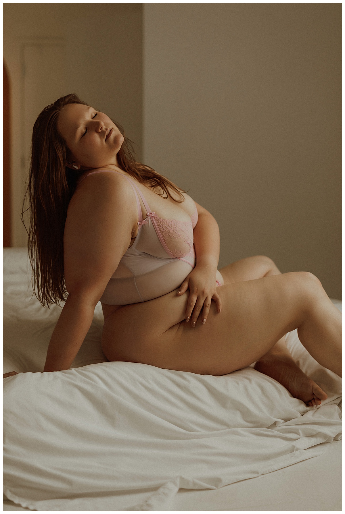 Person sits against a ned and leans back for Minneapolis Boudoir Photographer