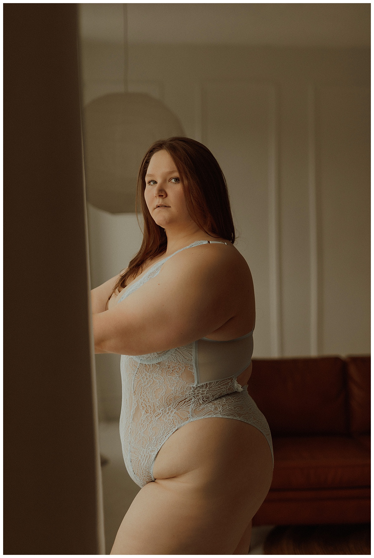 Woman wears blue lingerie for Minneapolis Boudoir Photographer