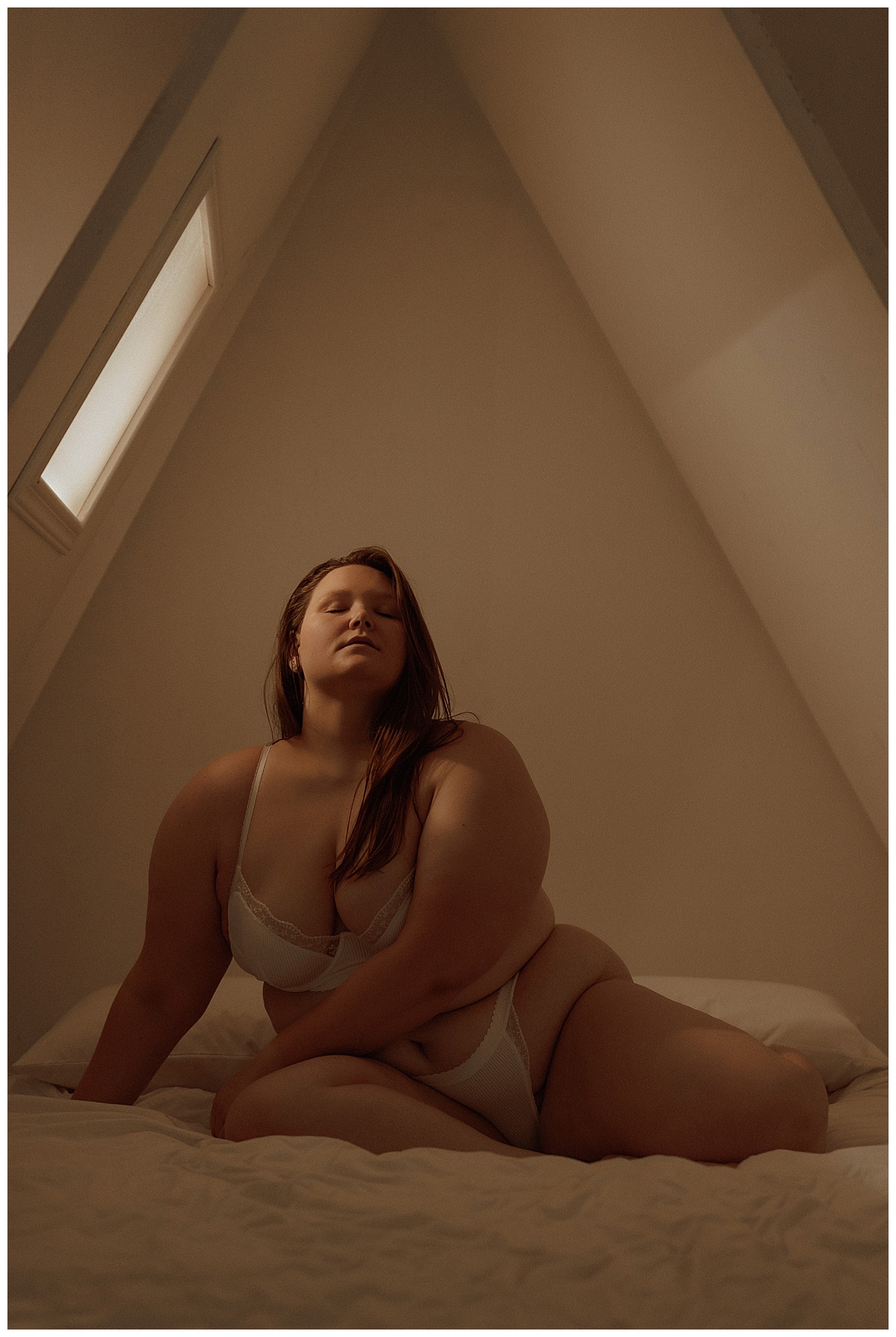 Person sits on the bed for Minneapolis Boudoir Photographer