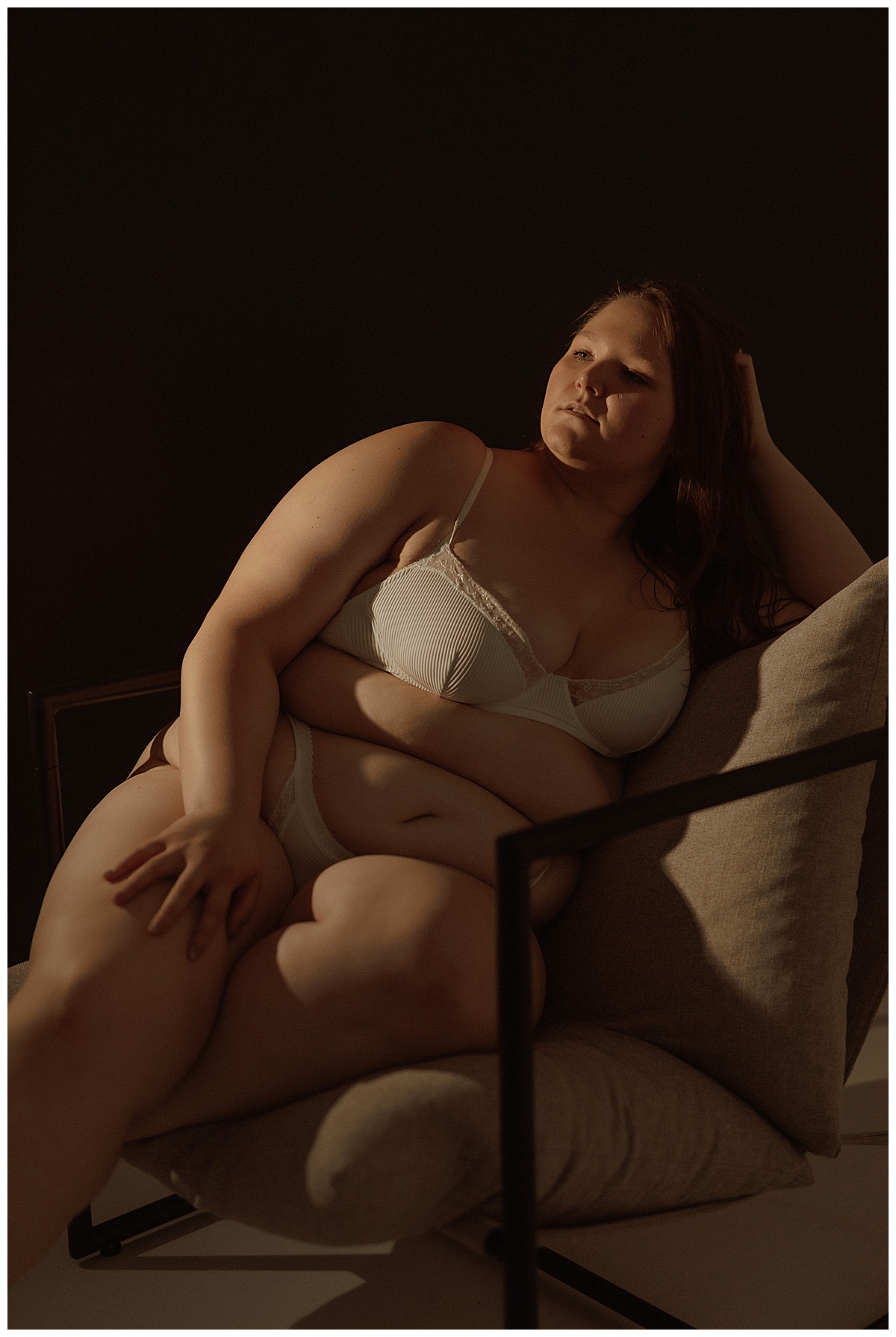 Female leans against the chair for Mary Castillo Photography