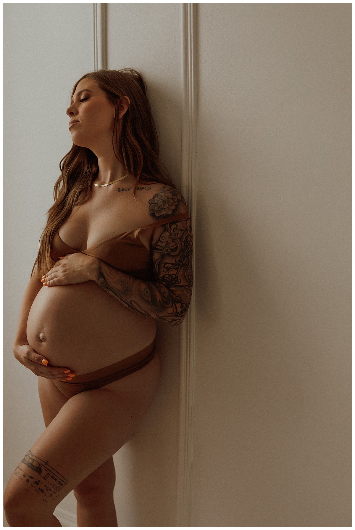 Mama to be holds pregnant baby bump for Mary Castillo Photography