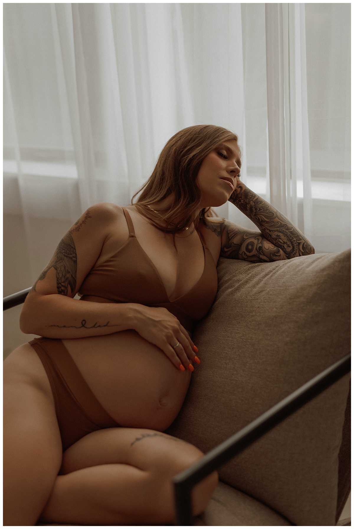 Woman holds baby bump for Minneapolis Boudoir Photographer