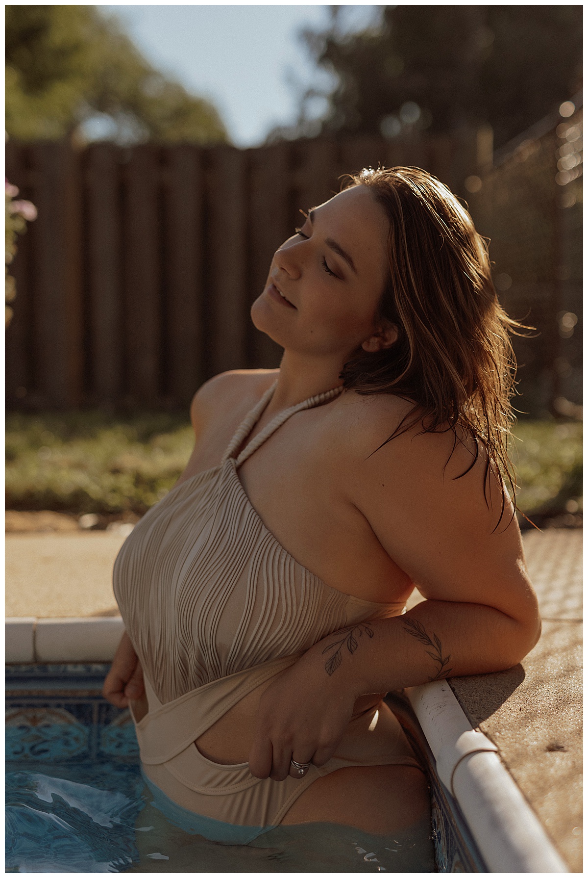 Person tugs at swimsuit while standing in the water for Mary Castillo Photography