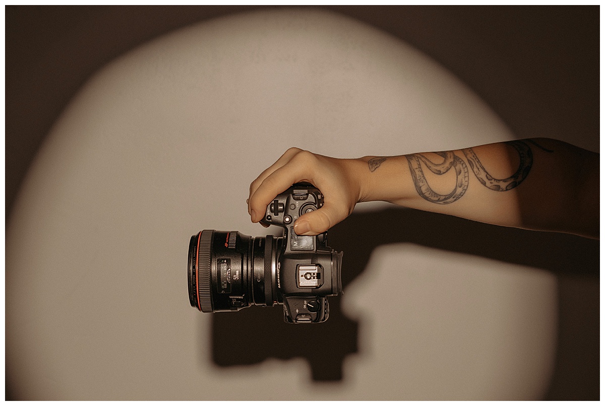 Adult holds her camera for Mary Castillo Photography