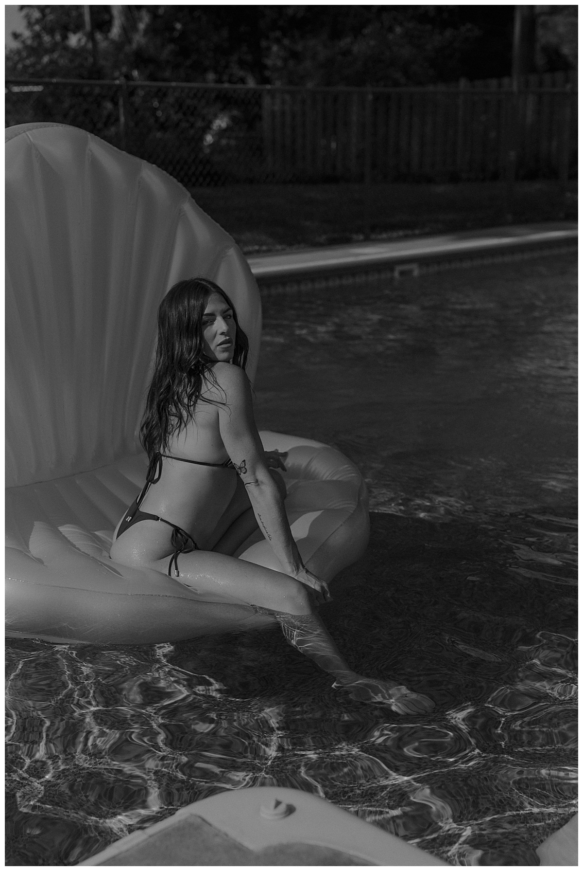 Female lounges on a pool float showing Why You Should Book a Boudoir Pool Session