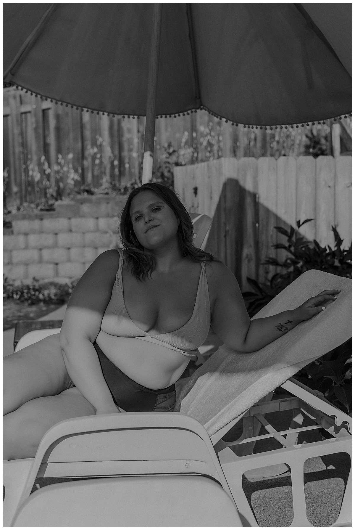 Woman lays on lounge chair by Mary Castillo Photography