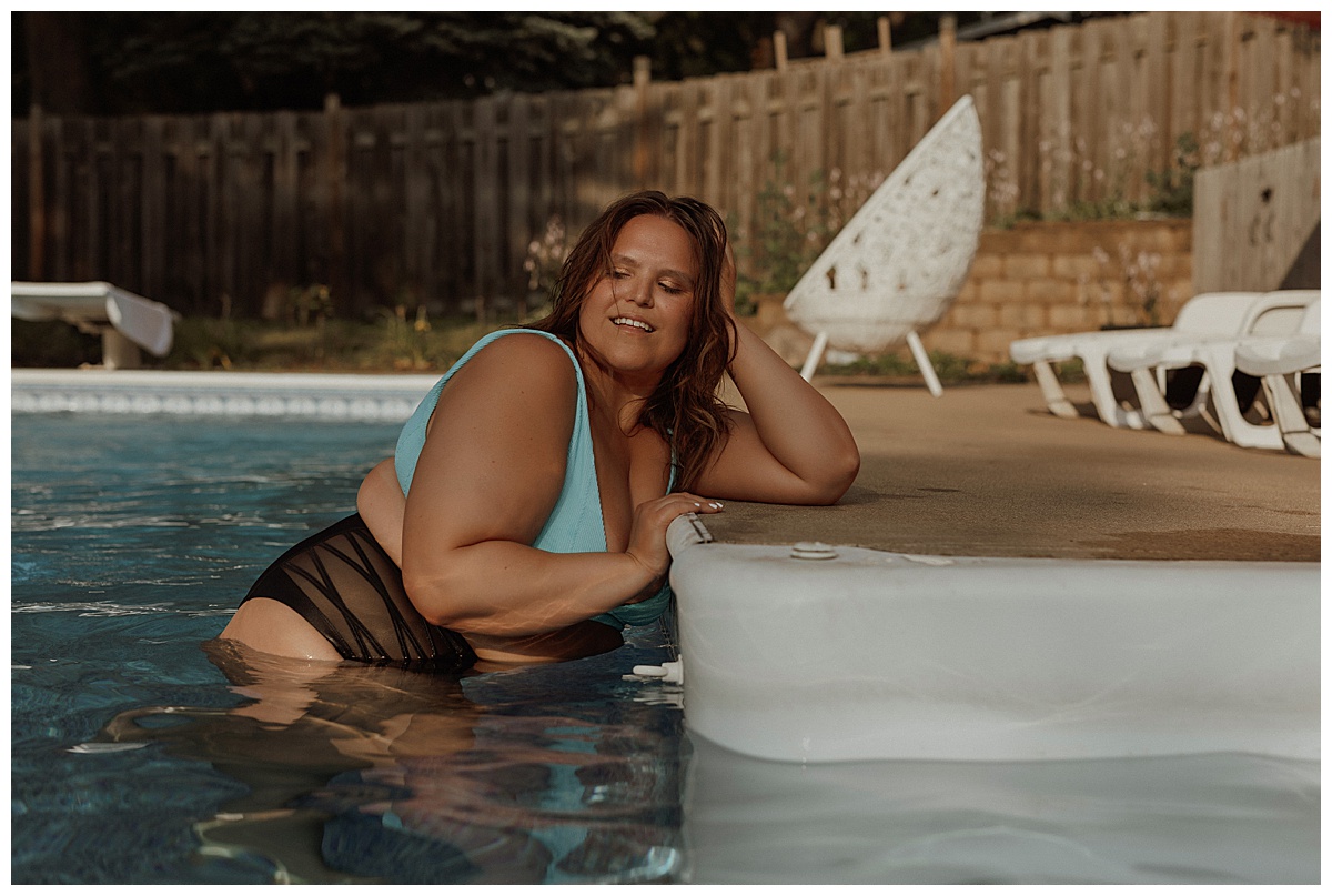 Adult leans over edge of the pool by Minneapolis Boudoir Photographer