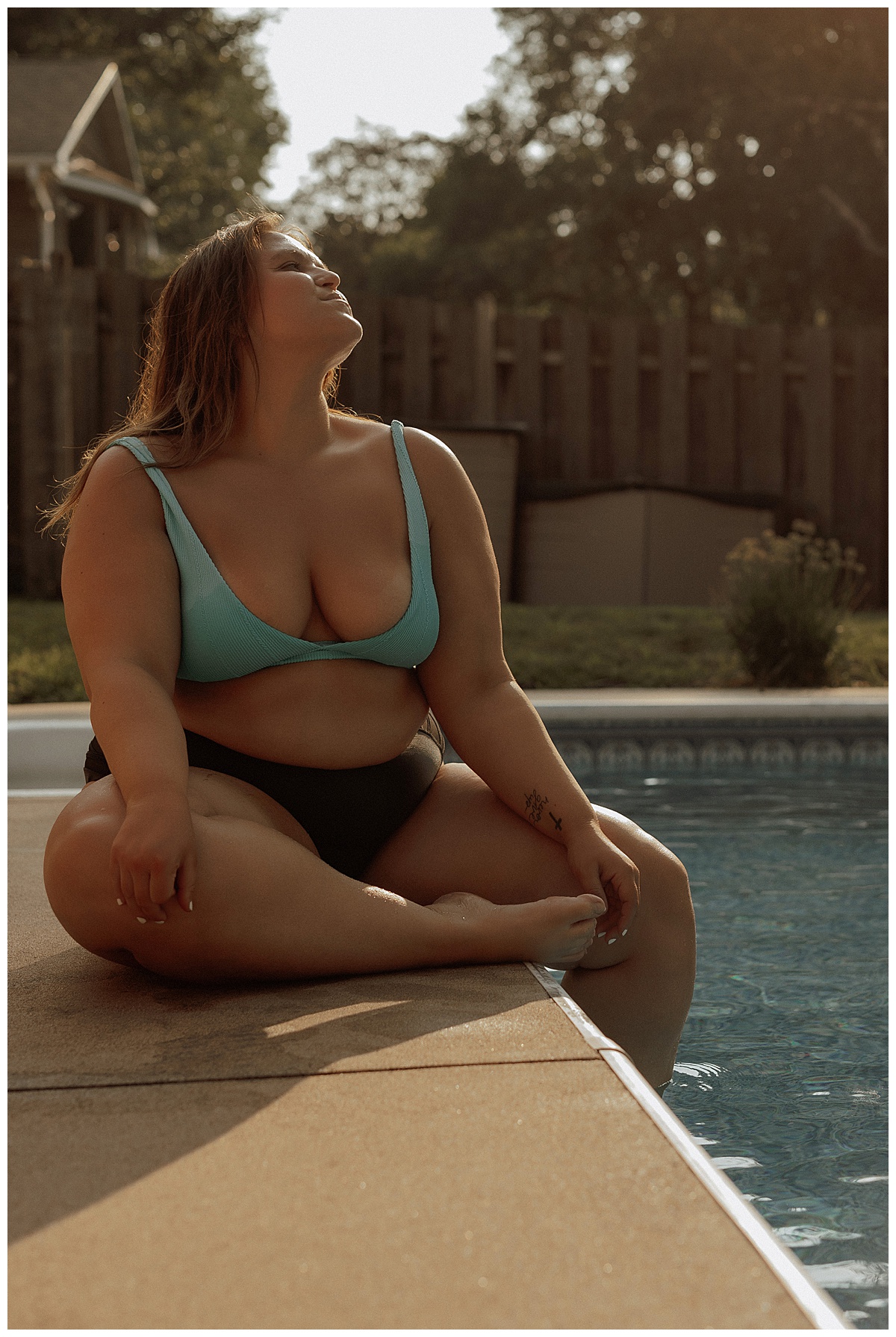 Woman sits on the edge of the pool following What to Wear for Your Pool Session 