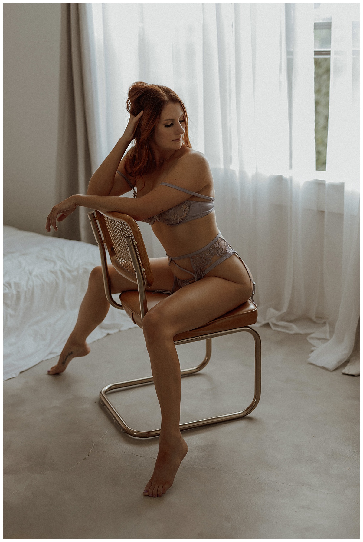 Person straddles the chair following one of the 3 Reasons Moms Should Book A Boudoir Session