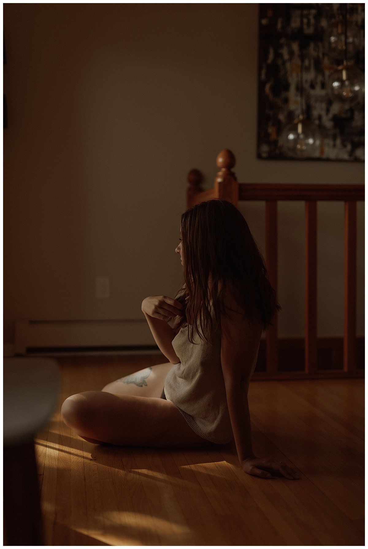 Adult sits on the floor Wearing a Cozy Outfits For a Boudoir Home Session