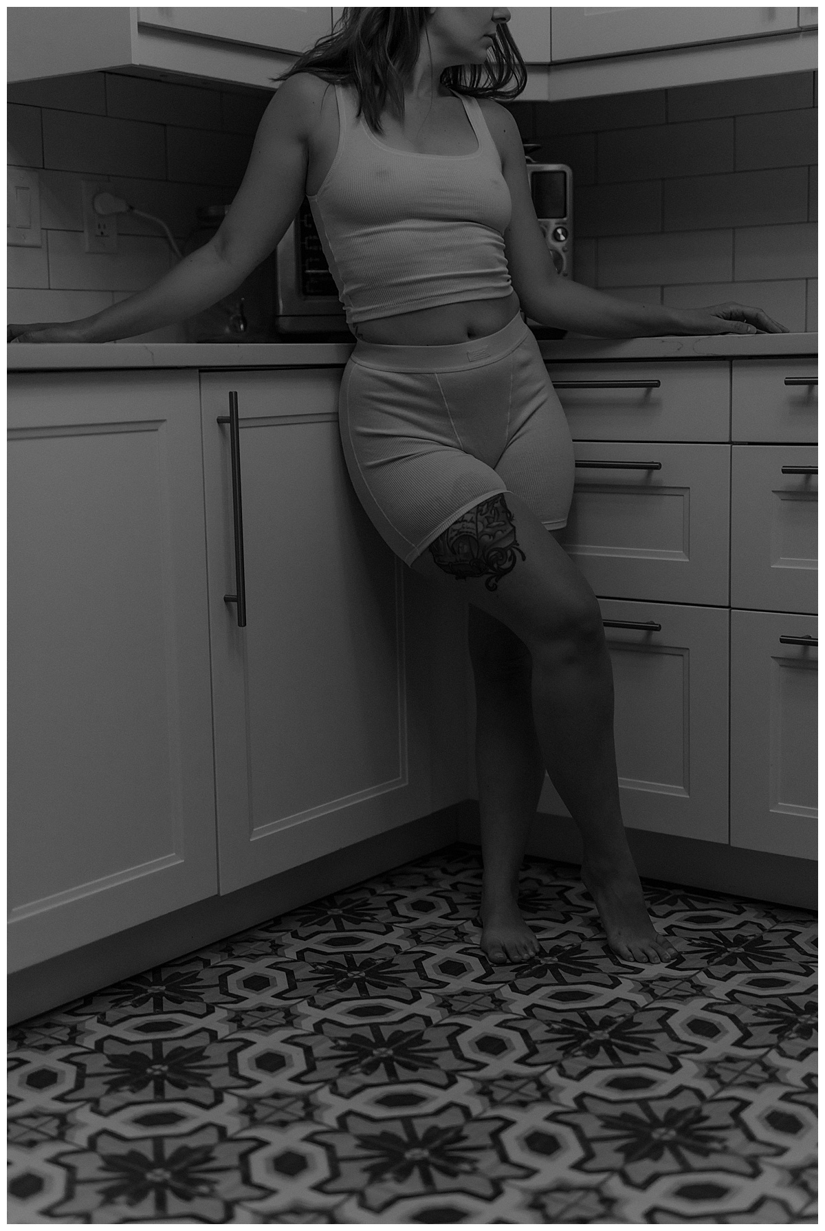 Female sits against the counter Wearing a Cozy Outfits For a Boudoir Home Session