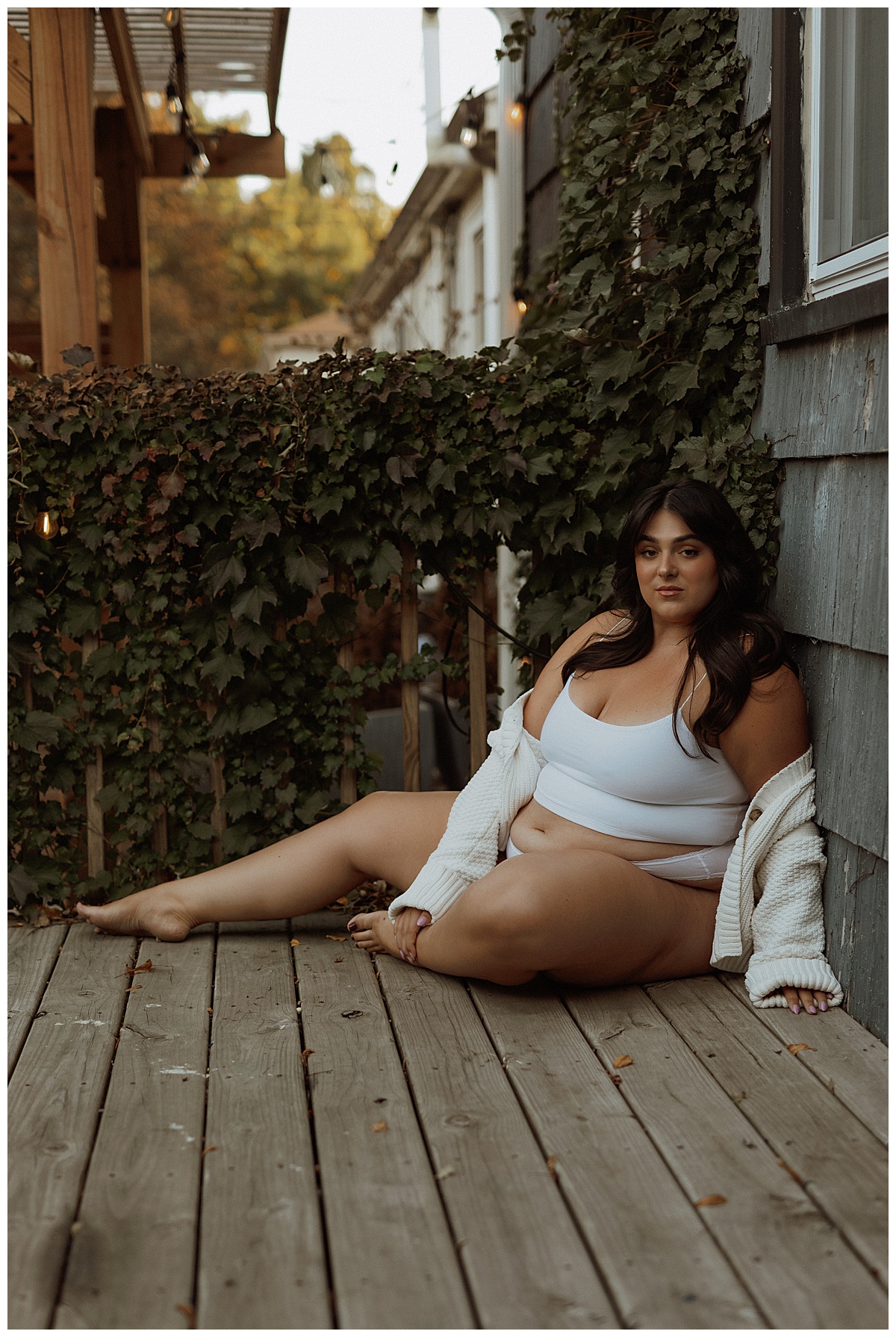 Person sits on the deck while modeling for Black Friday Sales for boudoir photographer